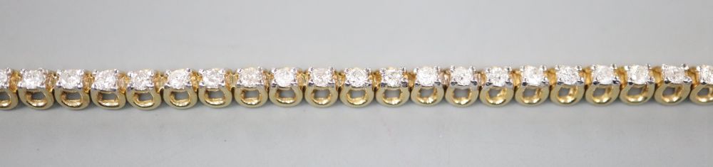 A modern 9ct gold and diamond set line bracelet, 17.7cm, gross 7 grams,